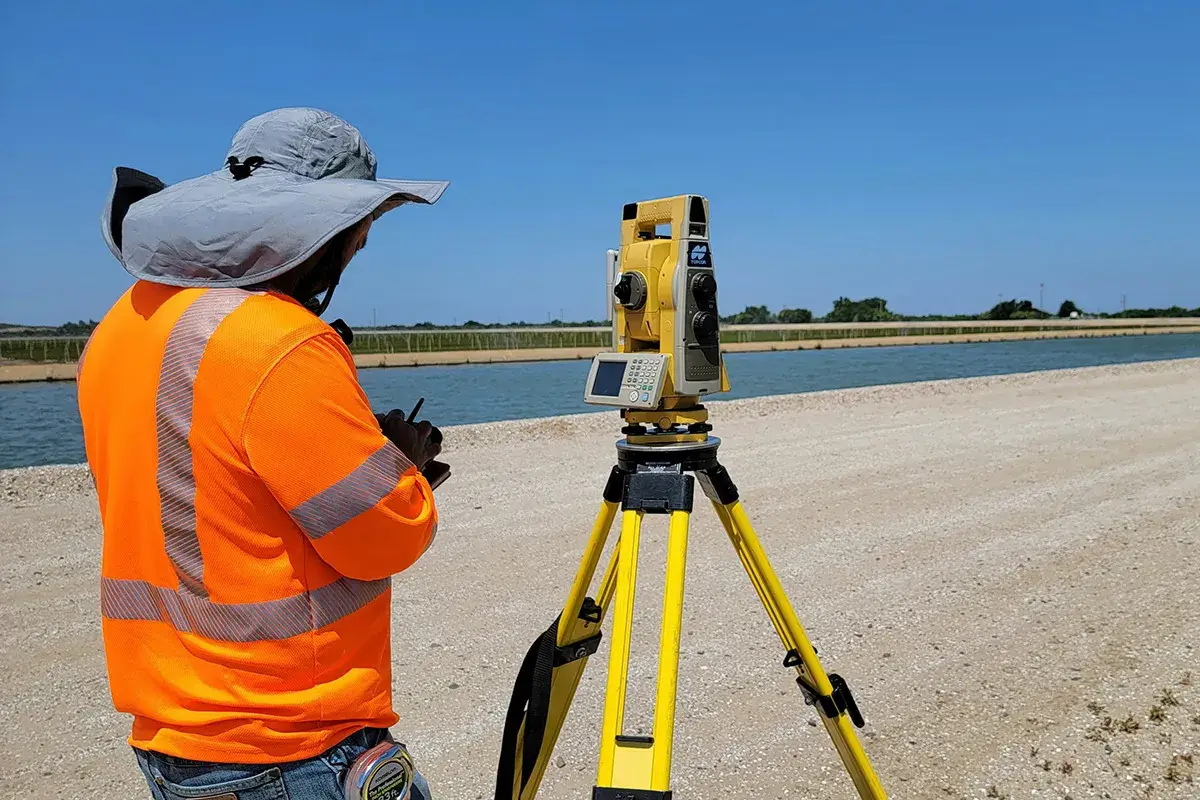 A surveyor in the field with a total station