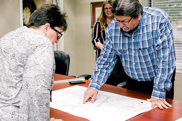 A civil engineer discussing campus plans with another employee.