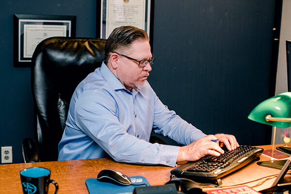 A professional surveyor working at his desk. 