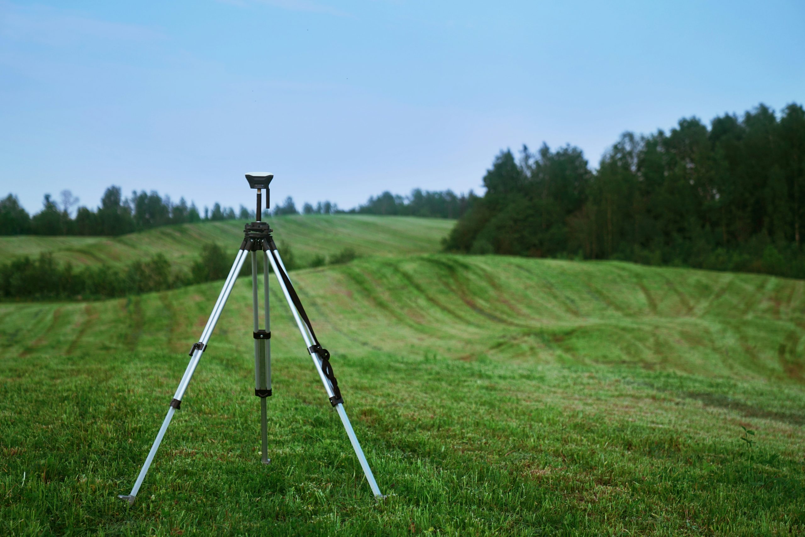 GPS survey equipment positioned in a field. 