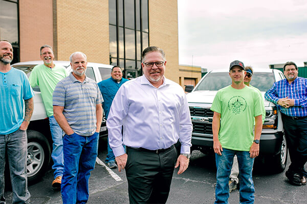 Shawn Collins, president of Sisemore & Associates, stands in front of his surveying and engineering team. 