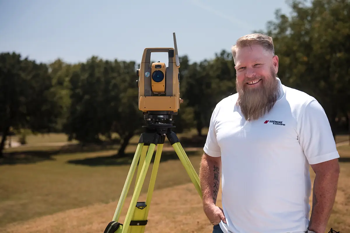 Man Next to Surveying Instrument